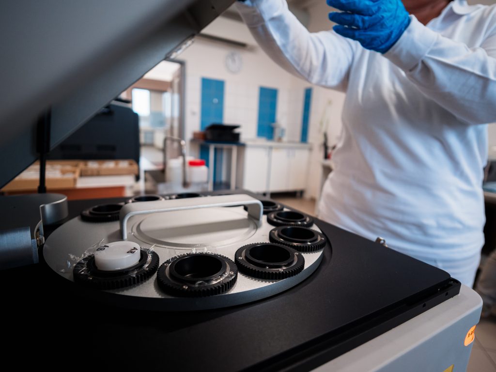 Laboratory worker handles rotary evaporator machine.